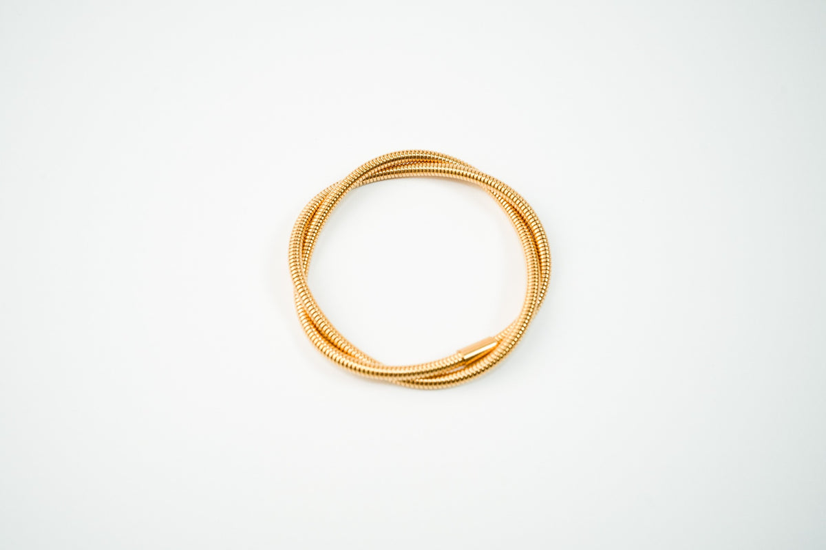 Pulsera acero inoxidable WATERPROOF de resorte enredada triple dorada